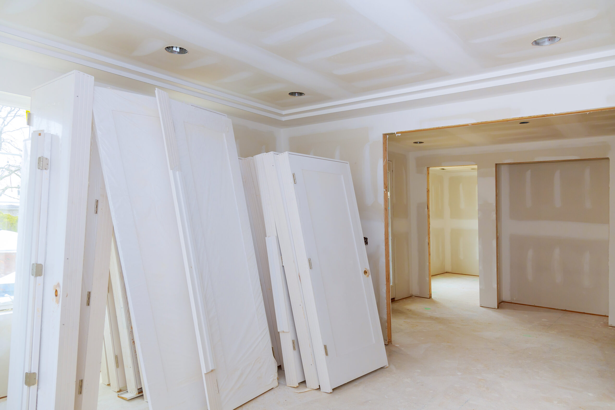 A sheetrock or drywall background. The taping and spackling have been done